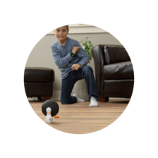 child playing with bowling ball toy