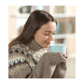 woman smelling a coffee