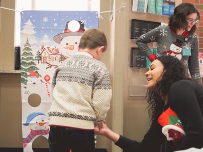 adult helping child with sensory game